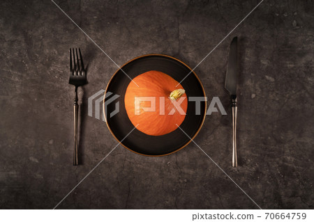 Vintage template with old metal plate with pumpkin on black stone background for Halloween design. Fall concept. Flat lay style. 70664759