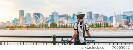 Biking outdoor cyclist on bike path at Old Port of Montreal view cityscape panoramic banner. Woman on bicycle wearing helmet. Summer sports city lifestyle 70665002