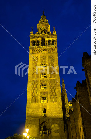 Bell Tower named Giralda in catholic Cathedral of Saint Mary in Seville, Spain 70665016