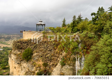 Scenic sight of Ronda with white houses built on high cliffs, Andalusia, Spain. Scenic sight of Ronda with white houses built on high cliffs, Andalusia, Spain. 70665031