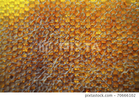 Drop of bee honey drip from hexagonal honeycombs Drop of bee honey drip from hexagonal honeycombs 70666102