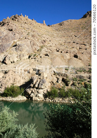 Minaret of Jam, Ghor Province in Afghanistan. The Jam minaret is a UNESCO site in a remote part of Central Afghanistan. Ruins of the Ghurid settlement on a hill across the Hari River from the minaret. Minaret of Jam, Ghor Province in Afghanistan. The Jam minaret is a UNESCO site in a remote part of Central Afghanistan. Ruins of the Ghurid settlement on a hill across the Hari River from the minaret. 70666120