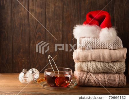Knitted sweaters and to cup of hot tea 70666182