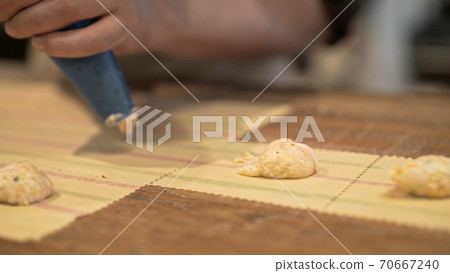 Squeezing from pastry bag, stuffing tortellini at the italian restaurant Squeezing from pastry bag, stuffing tortellini at the italian restaurant 70667240
