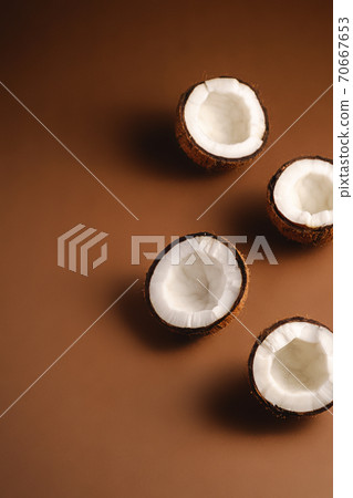 Coconut fruits on brown plain background, abstract food tropical concept, angle view copy space Coconut fruits on brown plain background, abstract food tropical concept, angle view copy space 70667653