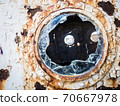An old abandoned ship's porthole 70667978