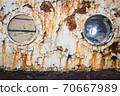 An old abandoned ship's porthole 70667989