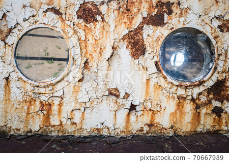 An old abandoned ship's porthole 70667989