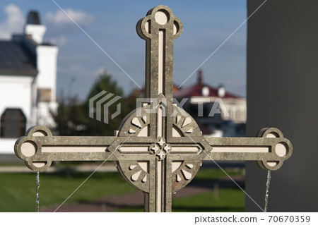 The marble cross is a monument with flowing water on the sides. 70670359