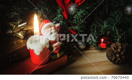 Santa Claus candle on wood table for Christmas content. Santa Claus candle on wood table for Christmas content. 70670440
