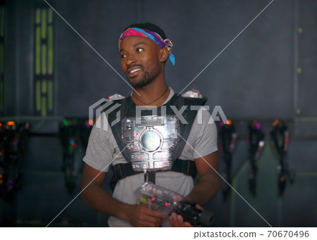 young man studio portrait science fiction spaceship game background laser tag gun 70670496