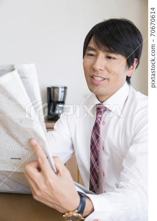 A man reading a newspaper A man reading a newspaper 70670614