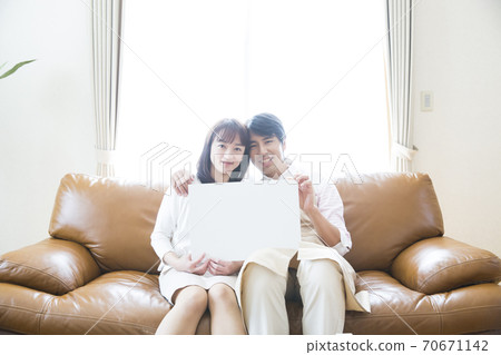 A couple with a message board 70671142