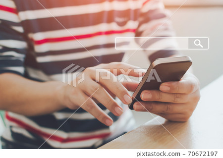 Man use smartphones to find what they are interested in Man use smartphones to find what they are interested in 70672197