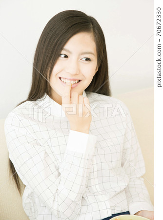 A woman eating popcorn 70672330
