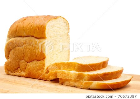 Homemade Japanese Hokkaido bread and slices on wooden board isolated. Homemade Japanese Hokkaido bread and slices on wooden board isolated. 70672387