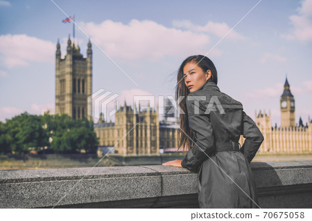 London trench coat business woman at Westminster. Fashion businesswoman in grey raincoat. Asian beauty model outdoor 70675058