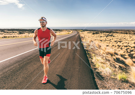 Triathlon man athlete running in tri suit training Triathlon man athlete running in tri suit training 70675096