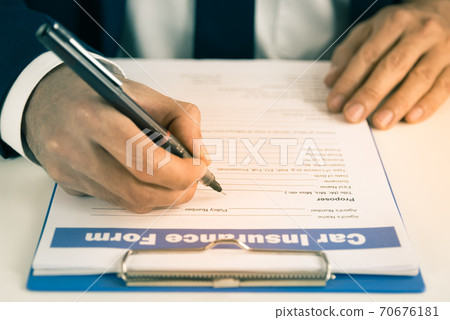Zoom Insurance Agent Hand Writing Car Insurance Claim Form or Document in Vintage Tone Zoom Insurance Agent Hand Writing Car Insurance Claim Form or Document in Vintage Tone 70676181