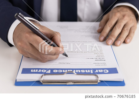 Insurance Agent Hand Writing Car Insurance Claim Form or Document Insurance Agent Hand Writing Car Insurance Claim Form or Document 70676185