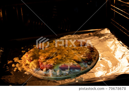 Pizza with cheese in the oven closeup Pizza with cheese in the oven closeup 70678678