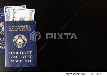 Belarusian passport and money dollars on wooden table Belarusian passport and money dollars on wooden table 70678716