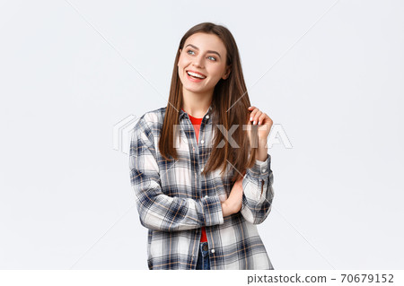 Lifestyle, different emotions, leisure activities concept. Dreamy and delighted, happy smiling woman, female student in checked casual shirt looking upper left corner with pleased expression 70679152