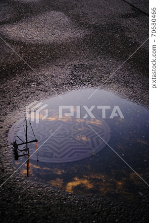 Reflective puddle in the evening sky 1 70680466