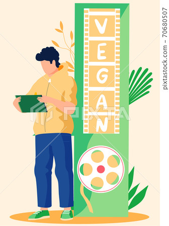 Young man with a tablet on the background of the inscription about veganism. Guy character working Young man with a tablet on the background of the inscription about veganism. Guy character working 70680507