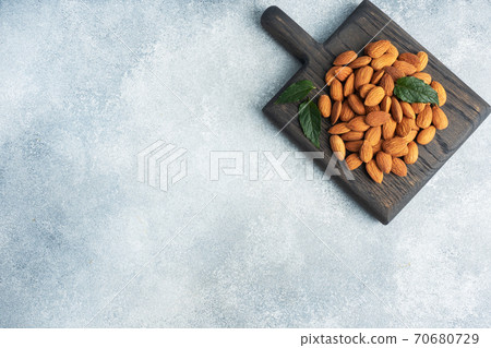 Peeled almonds on a wooden rustic background. Copy space. Peeled almonds on a wooden rustic background. Copy space. 70680729