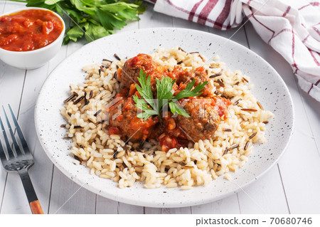 Beef meatballs and brown rice on a plate. Ready made portioned dish meat with garnish. Beef meatballs and brown rice on a plate. Ready made portioned dish meat with garnish. 70680746