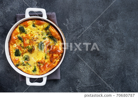 Baked omelet with broccoli in a ceramic dish. Dark concrete table. Copy space. Healthy diet food dish. 70680787