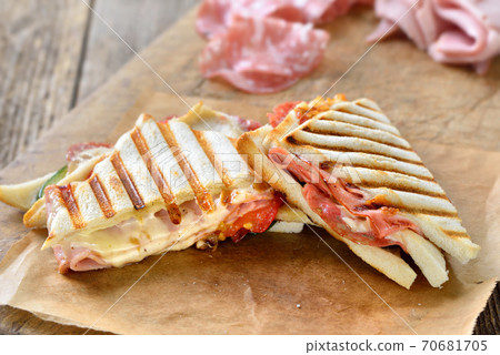 Pressed double panini with Italian salami, ham and cheese served fresh from the contact grill Pressed double panini with Italian salami, ham and cheese served fresh from the contact grill 70681705
