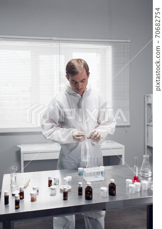 Laboratory scientist working in a lab with test tubes Laboratory scientist working in a lab with test tubes 70682754