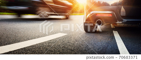 Car on asphalt road on summer day at park Car on asphalt road on summer day at park 70683371
