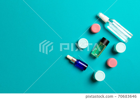 Cosmetics SPA branding mock-up, top view with copy space. set of tubes and jars of cream flat lay on colored background Cosmetics SPA branding mock-up, top view with copy space. set of tubes and jars of cream flat lay on colored background 70683646