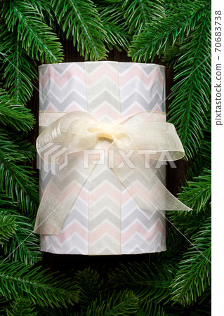 Top view of festive gift box decorated with green fir tree branches. Christmas time with copy space 70683738