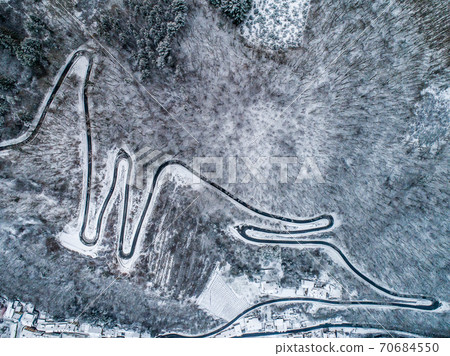 Seasons Concept winter snowy Aerial view Winding road serpentine mountain pass village Brodenbach Germany Seasons Concept winter snowy Aerial view Winding road serpentine mountain pass village Brodenbach Germany 70684550