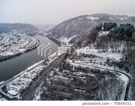 Seasons Concept winter Aerial view of the mosel village Brodenbach in Germany on a misty day Seasons Concept winter Aerial view of the mosel village Brodenbach in Germany on a misty day 70684551