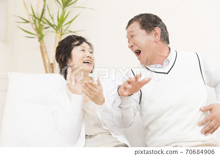 Senior couple looking at television Senior couple looking at television 70684906