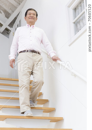 Senior men getting off the stairs Senior men getting off the stairs 70685520
