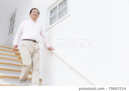 Senior men getting off the stairs 70685524