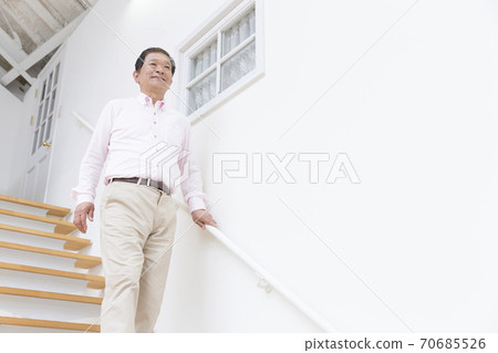 Senior men getting off the stairs 70685526