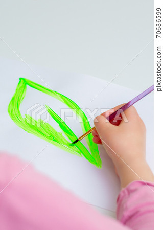Child is drawing green leaf Child is drawing green leaf 70686599