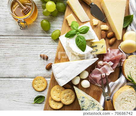 Various types of cheese  on a white wooden  background 70686742
