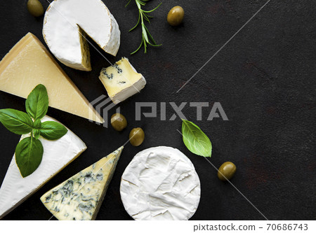Various types of cheese  on a black concrete background 70686743