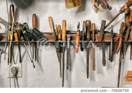 Variety of old vintage and modern household hand tools on a garage shelves in a DIY and renovations concept Variety of old vintage and modern household hand tools on a garage shelves in a DIY and renovations concept 70686790