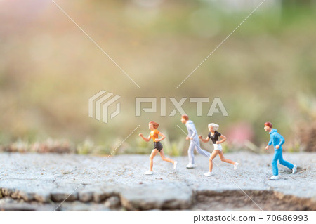 Miniature people : Traveler miniature with backpack stand and walking on meadow Miniature people : Traveler miniature with backpack stand and walking on meadow 70686993