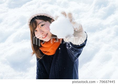Girl sitting on the snow 70687445