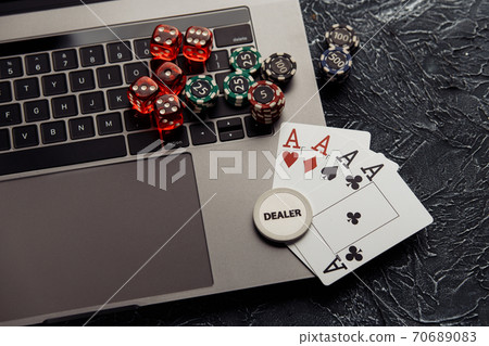 Chips, dices and playing cards with aces for poker online or casino gambling. Online casino concept Chips, dices and playing cards with aces for poker online or casino gambling. Online casino concept 70689083